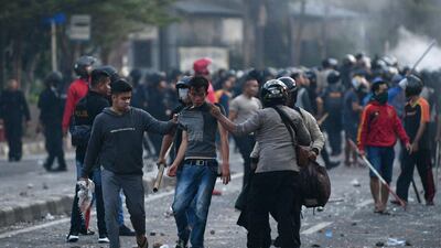 Police detain protesters after clashes in Jakarta, Indonesia. Reuters