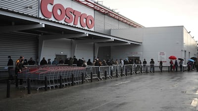 Shoppers queue outside a Costco wholesale store in Leeds. AFP