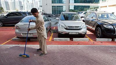 A man sweeps up debris this morning. Antonie Robertson / The National
