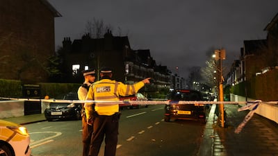 Police at the scene in Lessar Avenue. PA