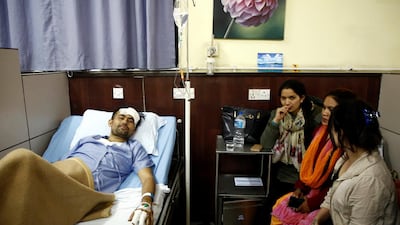 Basanta Bohara, 27, a survivor from the US-Bangla plane crash lies on a hospital bed while undergoing treatment in Kathmandu, Nepal. Navesh Chitrakar / Reuters