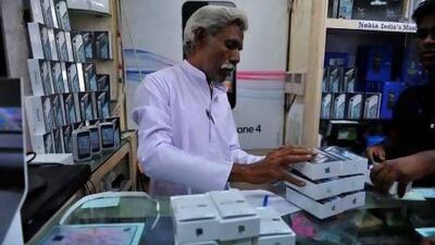 Apple is trying to make its smartphones cheaper in India through a rebate scheme. Noah Seelam / AFP