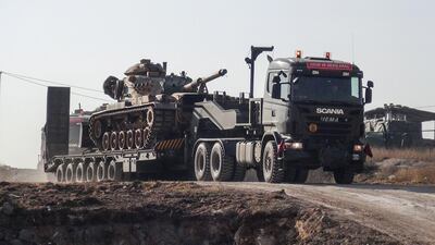 A photo made available by the Dogan New Agency shows Turkish army military trucks transporting armoured vehicles to reinforce the border units in close to the Syrian border on January 16, 2018. AFP