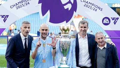 Manchester City chairman Khaldoon Al Mubarak, left, manager Pep Guardiola, CEO Ferran Soriano, and director of football Txiki Begiristain with the Premier League trophy at the Etihad Stadium. PA