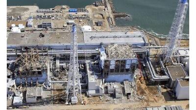 Damaged Unit 3, left, and Unit 4 of the crippled Fukushima nuclear power plant after the 2011 earthquake and tsunami. Air Photo Service / AP Photo