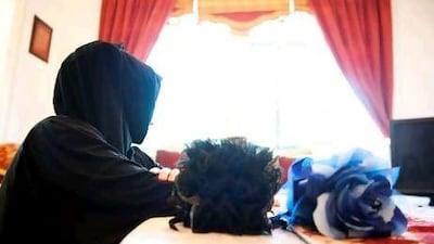 A young woman demonstrates how to wear a gamboo3a, a hair piece that adds volume to the crown. The accessory is a hairclip in the shape of a flower. Sarah Dea / The National