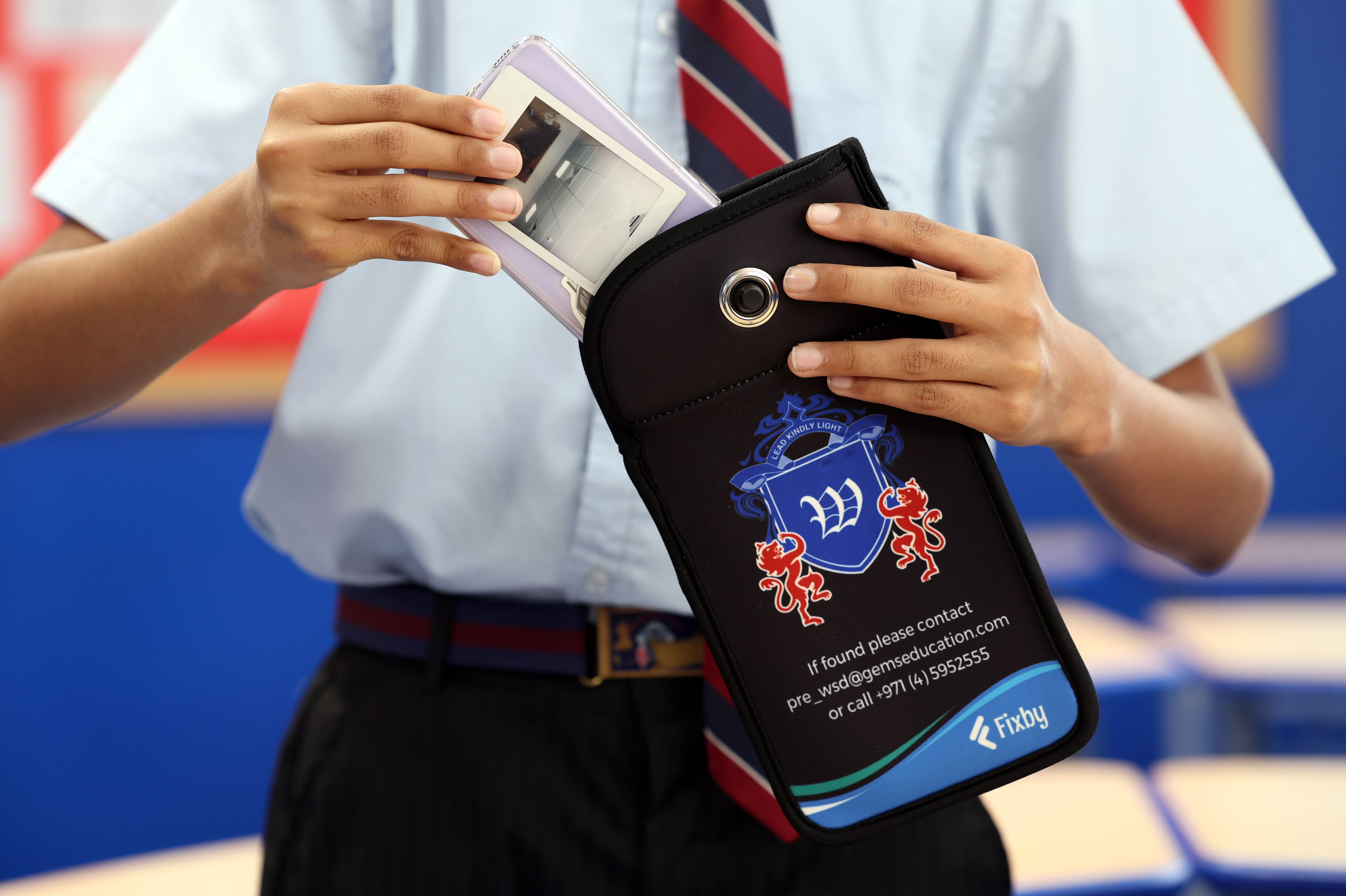 Many schools operate phone pouches, which keep the phones locked away during school time. Chris Whiteoak / The National