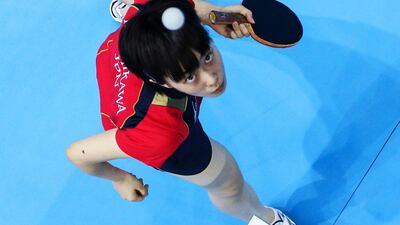 Kasumi Ishikawa of Japan serves during the Women's Singles Table Tennis quarter-final match against Yuegu Wang of Singapore. Chris McGrath/Getty Images