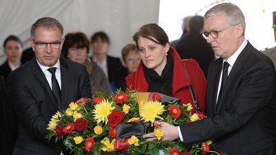Luftansa CEO Carsten Spohr, left, Germanwings CEO Thomas Winkelmann, right, and Stephanie Schroeder, centre, representative of the German Transport ministry, lay a wreath of flowers at the Vernet memorial, southwestern France, on March 24, 2016 to mark the first anniversary of the Germanwings tragedy in which a suicidal pilot crashed a plane into a mountainside, killing all 150 on board. Boris Horvat/ AFP