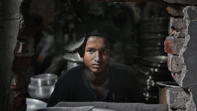 Rubel, 12, works at a factory that makes metal utensils in Dhaka, Bangladesh. AM Ahad / AP Photo