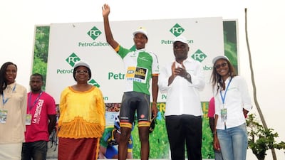 South African cyclist Jim Songezo, centre, celebrates on the podium after he was elected best combative rider of the Ninth Tropicale Amissa Bongo 2014 (Tour du Gabon) cycling race on January 19, 2014 in Libreville. Natnael Berhane won the race, becaming the first Black African to win it. Serge Rogers / AFP