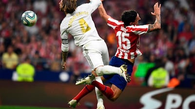 Real Madrid's Spanish defender Sergio Ramos and Atletico Madrid's Montenegrin defender Stefan Savic jump for the ball. AFP