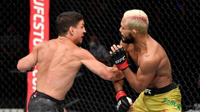 Joseph Benavidez, left, punches Deiveson Figueiredo. Getty Images