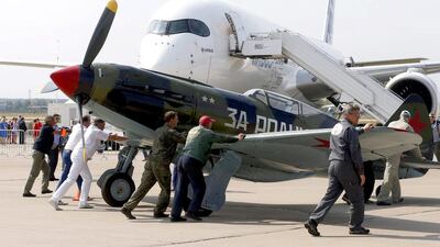 Russian servicemen push a vintage fighter plane into place at the MAKS 2015. Sergei Chirikov / EPA
