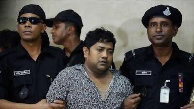Property tycoon Sohel Rana (centre) surrounded by Bangladesh police after his arrest.