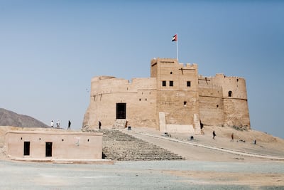Tourists explore one of the emirate's landmarks, the Fujairah Castle. Sarah Dea / The National