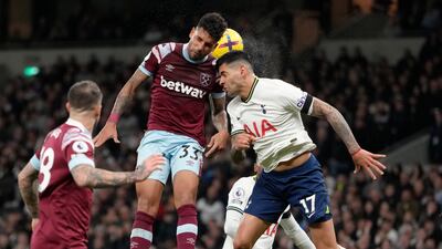 Tottenham's Cristian Romero, right, challenges for the ball with West Ham's Emerson Palmieri. AP