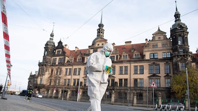 An investigator in forensic gear works behind a police cordon outside the historic Green Vault in Dresden. AFP
