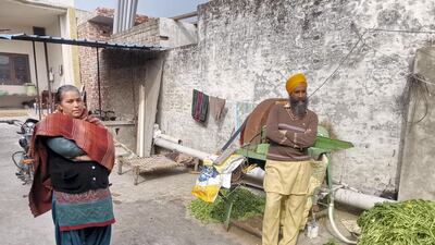 Sukhvir Kaur, 40, relies on help from her husband’s friend Balwinder Singh, right, to tend to the family farm while her husband is away.