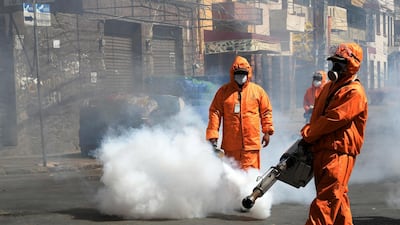 Municipal officials fumigate a street in Cochabamba, Bolivia. EPA