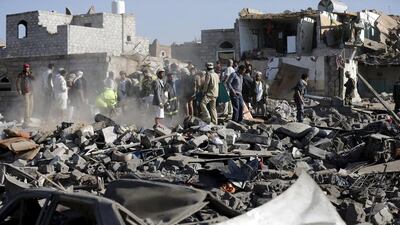 Civil defence workers and people search for survivors under the rubble of houses destroyed by an air strike near Sanaa Airport (REUTERS/Khaled Abdullah)