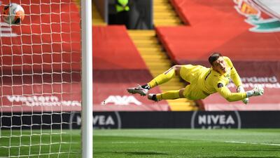 Burnley's goalkeeper Nick Pope dives in vain as Liverpool's Andrew Robertson's header goes past him for the opening goal at Anfield on Saturday. AP