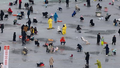 Visitors fish on a frozen river during the Hwacheon Sancheoneo Ice Festival in Gangwon province, South Korea. EPA