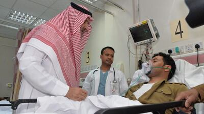 Saudi emir of Medina Faisal bin Salman bin Abdulaziz, left, speaking to a policeman who was injured in a bomb blast close to the Prophet Mohammed Mosque in the holy city of Medina on July 4, 2016. Saudi Press Agency via EPA