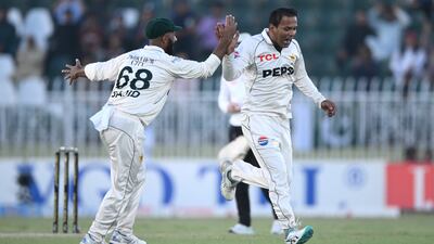 Pakistan bowler Noman Ali, right, celebrates after taking the wicket of Ollie Pope. Getty Images