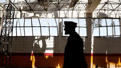 An Afghan man inspects the broken glass from his garage at the site of a suicide attack in Kabul. Omar Sobhani / Reuters