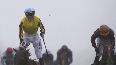 Jamie Spencer, in yellow, celebrates after riding Big Orange to win The Qatar Goodwood Cup at Goodwood in Chichester, England, on Thursday. Alan Crowhurst / Getty Images