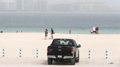 People at the Jumeirah open beach during the sandstorm in Dubai. Pawan Singh / The National