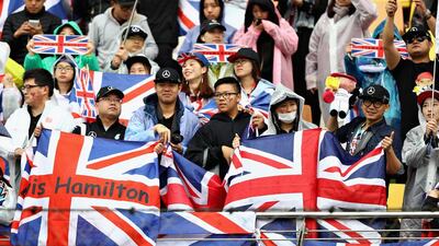 Mercedes-GP’s Lewis Hamilton of Great Britain and fans in the grandstand. Clive Mason / Getty Images