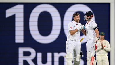 England's Joe Root celebrates with Gus Atkinson after hitting his first century in Australia. Getty Images