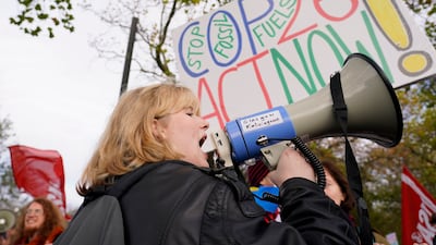 A young climate activist speaks through a megaphone. AP Photo