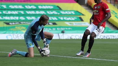 Tim Krul of Norwich City makes a save with United's Odion Ighalo in close attention. Getty