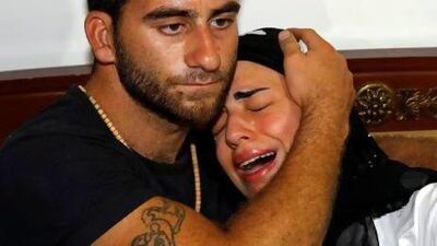 Fatima, right, daughter of Mohammed Jammo, is comforted by a relative. Jammo’s Lebanese wife and daughter were both in the house when he was shot.