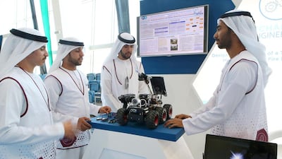 From left, Yaseem Alduwaila, Saeed Al Yammahi, Raad Alatouli and Taryam Al Katheri discuss the design and assembly of a mobile robot for fire incidents at the he Petroleum Institute’s Ebtikar Innovation contest. Ravindranath K / The National