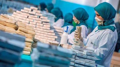 Factory workers package disposable protective masks along a production line in Morocco's Casablanca, as the North African country increases mask production due to the coronavirus pandemic. AFP