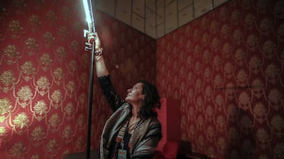 A volunteer photographer works on the lighting at Cinema Akil