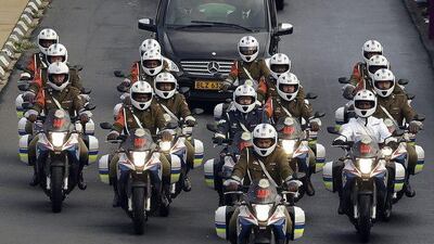 Defense force personnel and hospital staff salute the procession for former South African president Nelson Mandela as it leaves the military hospital in Pretoria. Themba Hadebe / AP Photo