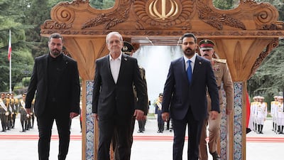 Mr Pezeshkian welcoming Mr Al Zaidi during a ceremony in Tehran. EPA