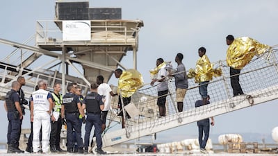 Passengers disembark from a French rescue ship in Boulogne after their inflatable boat caught fire during an attempt to cross the English Channel. AFP