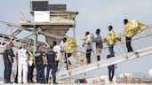 Passengers disembark from a French rescue ship in Boulogne after their inflatable boat caught fire during an attempt to cross the English Channel. AFP