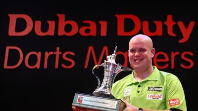 Michael van Gerwen is all smiles with the trophy. Francois Nel / Getty