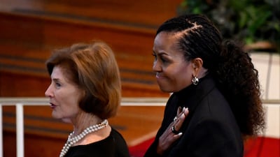 Former first ladies Michelle Obama and Laura Bush look on during the tribute service. AFP