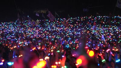 Spectators wear LED wristbands while watching Coldplay perform on the Pyramid Stage at the Glastonbury Festival, Worthy Farm in Somerset. PA