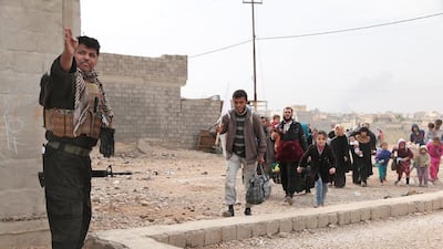 Civilians escape the fighting in Mosul's Samah district and are directed to safety by a soldier from the Golden Division. (Photo by Florian Neuhof)