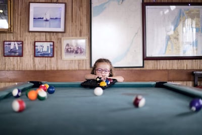 Ella-May Elba-Pawsey, 4, arranges the billiard balls at the Ras Al Khaimah sailing club. Reem Mohammed / The National