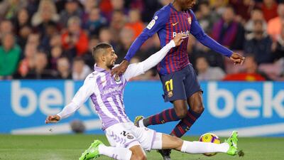 Barcelona's Dembele is tackled by Real Valladolid's Joaquin Fernandez. AP Photo